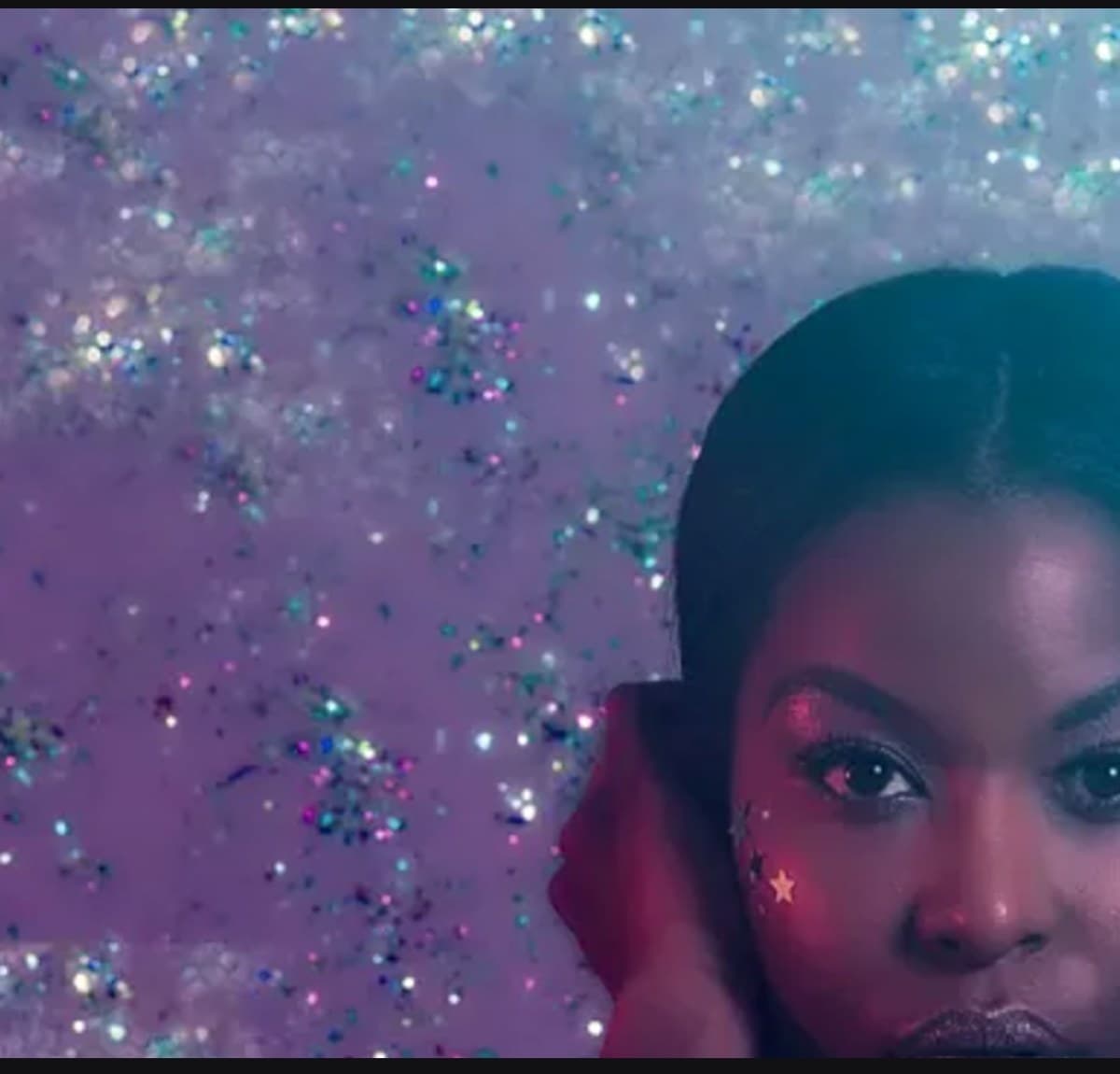Bevlove photographed against a glitter backdrop